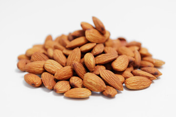 heap of almond nuts on white