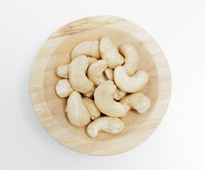 wooden bowl of cashew nuts on white background