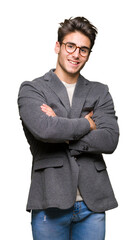 Young business man wearing glasses over isolated background happy face smiling with crossed arms looking at the camera. Positive person.