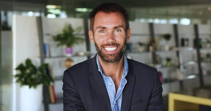 Head shot of smiling middle-aged businessman in formal suit posing at workplace. Shot of successful businessman, company CEO, HR manager or owner, professional team member, office employee portrait