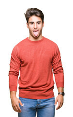 Fototapeta premium Young handsome man over isolated background sticking tongue out happy with funny expression. Emotion concept.