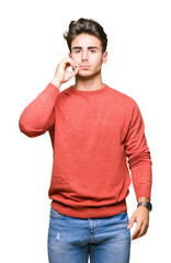 Young handsome man over isolated background mouth and lips shut as zip with fingers. Secret and...