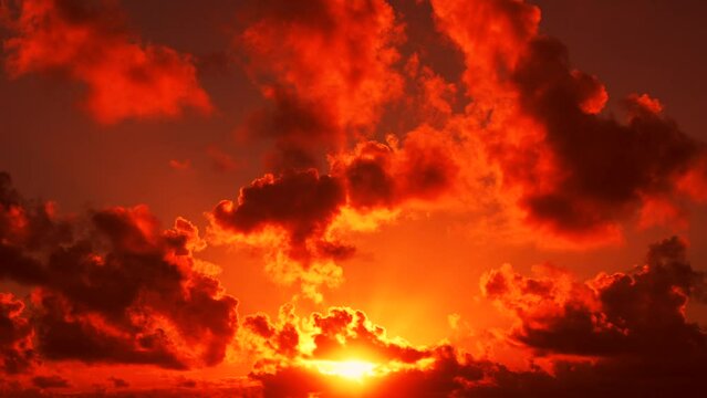 Amazing colorful illuminated clouds and sunshine in the red sunset sky. Happy and peaceful life on a beautiful planet Earth. Nature lifestyle copy space background