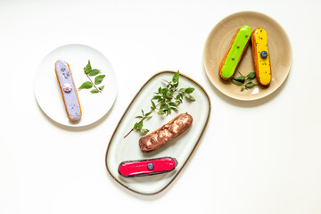 Set of eclairs cakes with different flavors. Sweet food background