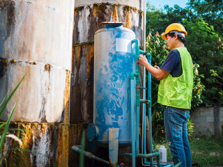 Asian man engineer controlling the quality of water places operating industrial water purification...
