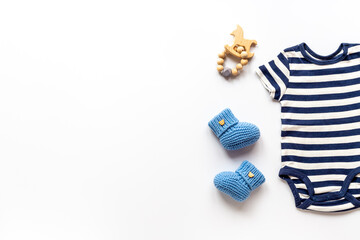 Flat lay of blue baby clothing and accessories. Kids bodysuit and shoes flat lay