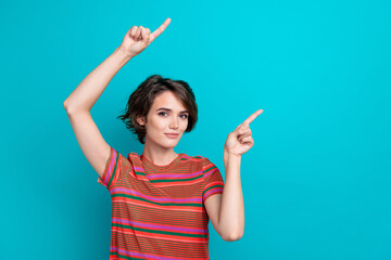 Photo of optimistic nice woman with bob hairstyle dressed striped t-shirt indicating at sale empty space isolated on teal color background