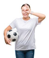 Young beautiful caucasian woman holding soccer football ball over isolated background with happy face smiling doing ok sign with hand on eye looking through fingers