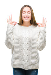 Young beautiful caucasian woman wearing winter sweater over isolated background relax and smiling with eyes closed doing meditation gesture with fingers. Yoga concept.