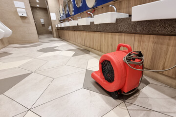 Floor dryer fan used in public washroom and toilet to dry the floor after washing and cleaning