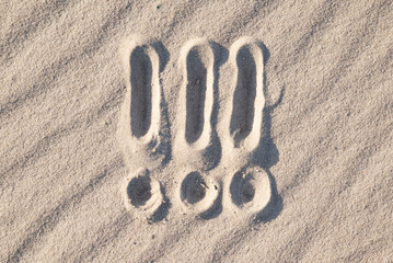 Three exclamation marks on sand. Symbol of emotion, pay attention, mark written on sand