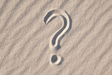 Fototapeta na wymiar Question mark on sand beach. Concept of questioning, wonder, ask questions