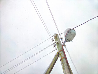 Old pole with wires against the sky. Electric transmission line. Eco-friendly energy