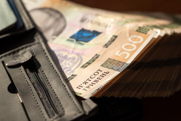 Mens wallet with 500 hryvnia banknotes. Full wallet of cash, rich person, big sum of money