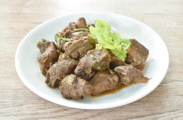 steamed pork bone with black sweet soy sauce topping celery on plate