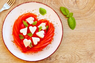 Valentine Italian Caprese salad with heart shaped tomatoes,heart shaped mozzarella cheeses,basil...