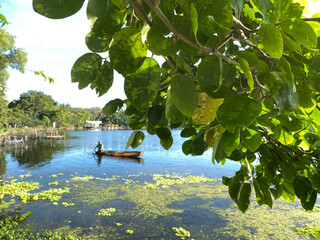 San Pablo City, Laguna, Philippines–January 3, 2024: Unrecognizable lake boatman maneuvers his...