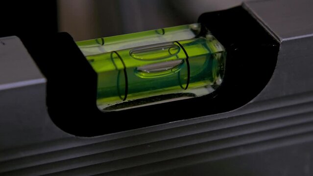 close-up shot measuring the inclination of the plane with the spirit level construction and carpentry work tool