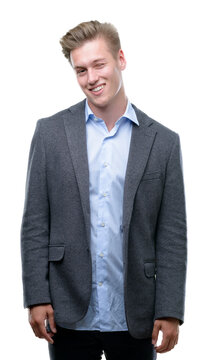 Young handsome blond business man winking looking at the camera with sexy expression, cheerful and happy face.