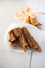 A handful of dried chicken meat, marinated with spices.
