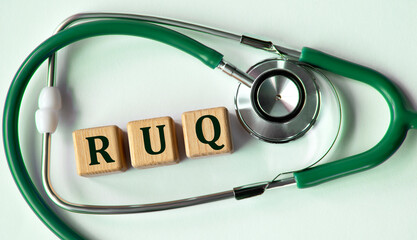 Cubes with the abbreviation RUQ on the background of a stethoscope.