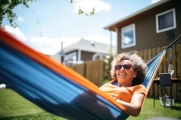 Poster woman relaxing in hammock beside mobile tiny home © studioworkstock