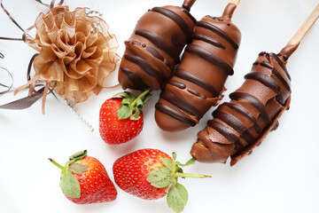 chocolate fruit dessert. strawberries in chocolate glaze isolated on white background and valentine's heart	