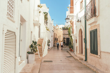 Couple walking the streets of Monopoli in Puglia, Italy	