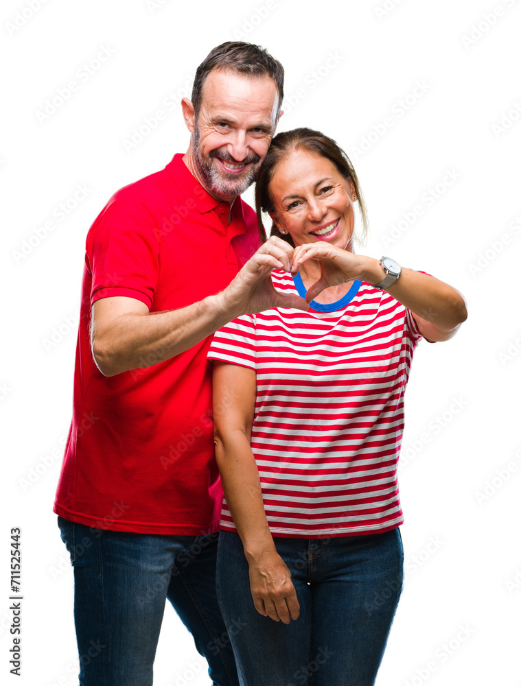 Canvas Prints Middle age hispanic couple in love over isolated background smiling in love showing heart symbol and shape with hands. Romantic concept.