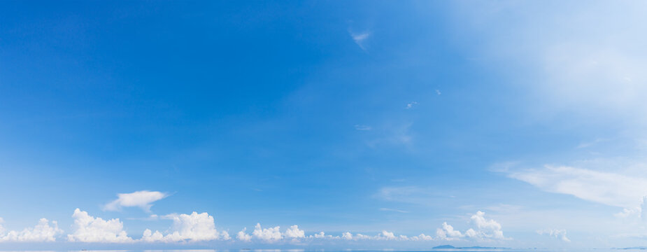 Panorama blue sky with white fluffy clouds