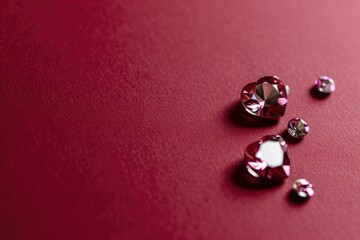 A close up of a bunch of diamonds on a red surface.