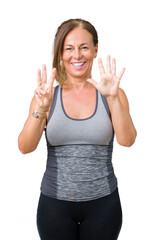 Beautiful middle age woman wearing sport clothes over isolated background showing and pointing up with fingers number eight while smiling confident and happy.