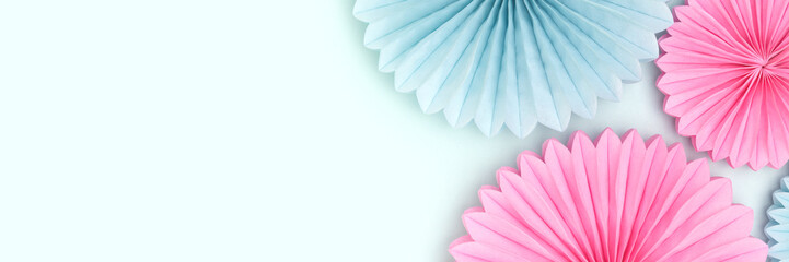Banner with tissue paper fans in a blue and pink colors. Creative composition with place for text.
