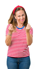 Beautiful middle age woman wearing casual stripes t-shirt over isolated background Doing money gesture with hand, asking for salary payment, millionaire business