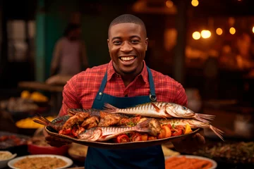 Schilderijen op glas Grilled Seafood Charm: In Luanda, Angola, a Chef Delights in Grilling Fish in an Open-Air Restaurant, Infusing the Atmosphere with Good Disposition and Barbecue Bliss © Mr. Bolota