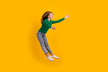 Fototapeta na wymiar Full length photo of beautiful jumping friendly young teenager woman open arms welcome to team isolated on yellow color background