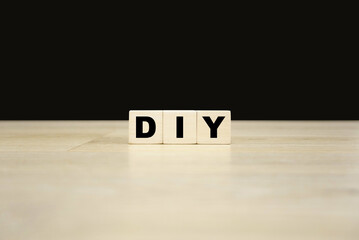 DIY word written on wooden blocks. DIY text for your desing, concept.