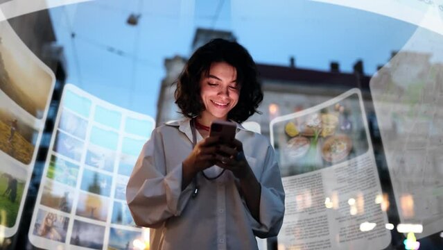 An incredibly beautiful curly-haired woman is using an augmented reality phone to browse web pages, apps, and social networks. A woman uses her phone while walking down a city street at night
