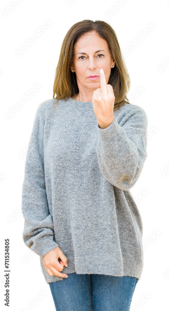 Sticker Beautiful middle age woman wearing winter sweater over isolated background Showing middle finger, impolite and rude fuck off expression