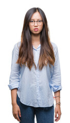 Young asian business woman wearing glasses over isolated background skeptic and nervous, frowning upset because of problem. Negative person.