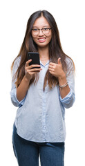 Young asian woman texting using smartphone over isolated background happy with big smile doing ok sign, thumb up with fingers, excellent sign
