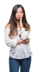 Young asian woman over isolated background thinking looking tired and bored with depression problems with crossed arms.