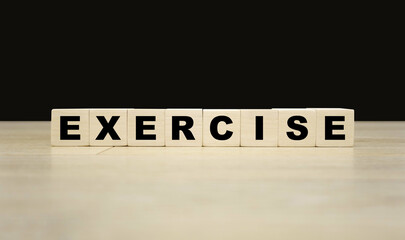Exercise word written on wooden blocks. Exercise text for your desing, concept.