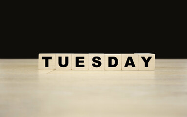 Tuesday word written on wooden blocks. Tuesday text for your desing, concept.