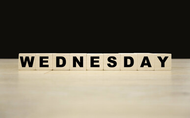 Wednesday word written on wooden blocks. Wednesday text for your desing, concept.