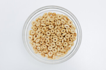 Top view of loops cereals served in bowl on white background