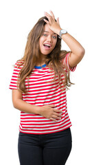 Young beautiful brunette woman wearing stripes t-shirt over isolated background surprised with hand...