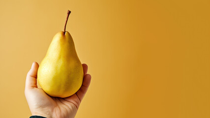 Hand holding pear fruit isolated on pastel background
