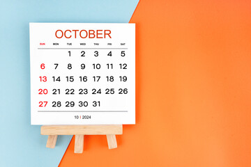 2024 October calendar page on blue and orange background.