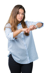 Young beautiful brunette business woman over isolated background In hurry pointing to watch time, impatience, upset and angry for deadline delay